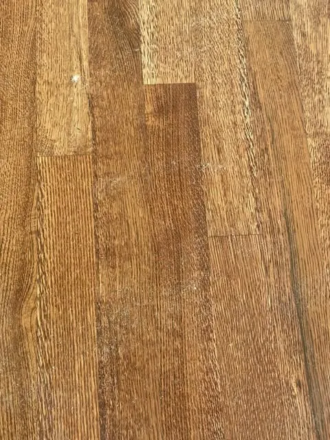 Worn white oak floor showing traffic patterns prior to dustless sanding in West Linn